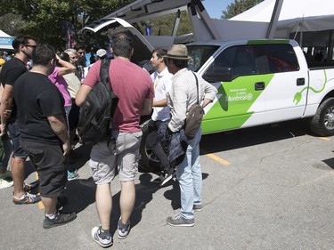 A crowd gathers around the electric truck that was unveiled by the city of Montreal at the Formula E track, on Saturday July 29, 2017. (Pierre Obendrauf / MONTREAL GAZETTE)