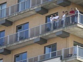 Neighbouring residents get to watch the Formula E qualifying from their balcony on René Lévesque Blvd. on Saturday, July 29, 2017.