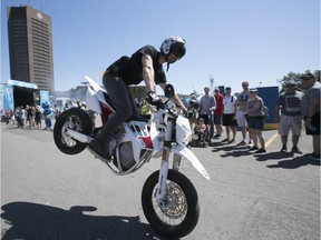 Julien Dupont from France shows his talents on a electric motorcycle, during the Formula E sideshow on Sunday July 30, 2017.