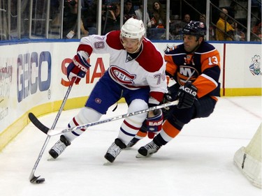 Andrei Markov #79 of the Montreal Canadiens skates with the puck against Bill Guerin #13 of the New York Islanders on January 15, 2008 at Nassau Coliseum in Uniondale, New York.