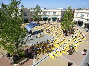 Hundreds of people stretch together as they participate in a group yoga session to celebrate Canada's 150th birthday as a community at the McArthurGlen Designer Outlet on July 1, 2017 in Richmond, Canada.