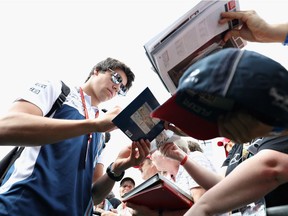 Lance Stroll of Canada and Williams signs autographs for fans  before final practice for the Formula One Grand Prix of Austria at Red Bull Ring on July 8, 2017 in Spielberg, Austria.  (Photo by Mark Thompson/Getty Images)