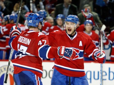 Andrei Markov #79 celebrates the second period goal by Marc-Andre Bergeron #47 of the Montreal Canadiens during the NHL game against the Toronto Maple Leafs on April 10, 2010 at the Bell Centre in Montreal, Quebec, Canada.