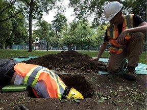 Under the guidance of archaeologist Michel Plourde, right, technician Elea Gutierres digs a test pit in Outremont Park, hoping to find artifacts that might indicate the presence of the original village of Hochelaga.