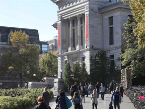 McGill students walk by the Redpath Museum at McGill University campus.