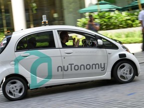 A safety driver sits in a driverless car during a trial run in Singapore in 2016. In a few years, Josh Freed predicts, we'll be able to kick back and catch up on TV as our cars chauffeur us to our destination.
