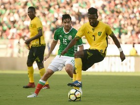 Shaun Francis (#7) of Jamaica battles with Rodolpfo Pizarro (#15) during their CONCACAF Gold Cup semifinal match on July 23, 2017 at The Rose Bowl in Pasadena, California.