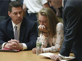 Michelle Carter cries while flanked by defence attorneys Joseph Cataldo, left, and Cory Madera, after being found guilty of involuntary manslaughter in the suicide of Conrad Roy III, Friday, June 16, 2017, in Bristol Juvenile Court in Taunton, Mass.