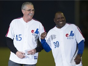 Former Montreal Expos Steve Rogers and Tim Raines share a laugh during a ceremony prior to a pre-season game between the Toronto Blue Jays and the New York Mets Friday, March 28, 2014 in Montreal.