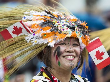 A colourful participant smiles as she entertains the crowd during the annual Canada Day parade in Montreal, Saturday, July 1, 2017.