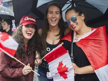 Members of the crowd smile as they watch the annual Canada Day parade in Montreal, Saturday, July 1, 2017.