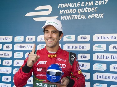 Lucas Di Grassi, of Brazil, celebrates after winning the pole position for the Montreal Formula ePrix electric car race, in Montreal on Saturday, July 29, 2017. THE CANADIAN PRESS/Ryan Remiorz