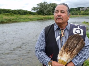Chippewas of the Thames First Nation chief Myeengun Henry beside the Thames River near Plover Mills Drive, where energy company Enbridge's Line 9 runs.