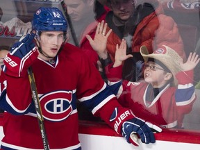 A young fan tries to get the attention of Canadiens' Brendan Gallagher during a game in 2014. Ticket stubs are a way for fans to instantly remember fun times they've had at sporting events.