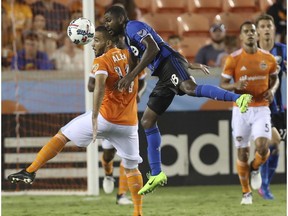Houston Dynamo midfielder Alex (14) and Montreal Impact defender Chris Duvall (18) vie for a header during the second half of an MLS soccer match Wednesday, July 5, 2017, in Houston.