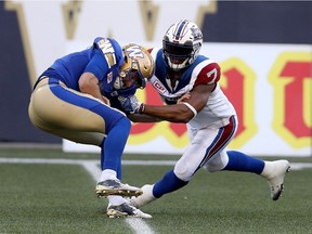 Winnipeg Blue Bombers quarterback Matt Nichols (15) is sacked by Montreal Alouettes defensive end John Bowman (7) in Winnipeg July 27, 2017.