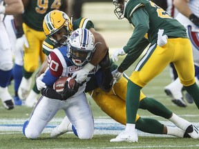 Montreal Alouettes' Tyrell Sutton is tackled by Edmonton Eskimos' Korey Jones during first half CFL action in Edmonton on Friday, June 30, 2017.