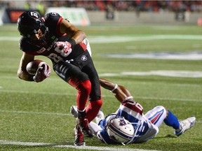 Redblacks wide-receiver Brad Sinopoli scores a touchdown past Alouettes defensive-back Tyree Hollins during second half CFL football action in Ottawa on Wednesday, July 19, 2017.