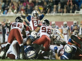 Alouettes' Tyrell Sutton (20) celebrates a touchdown against the Calgary Stampeders in Montreal on Friday, July 14, 2017.