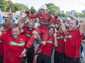 Lucas Di Grassi of Brazil, with ABT Schaeffler, is hoisted by his team after winning the driver's title at the Montreal Formula ePrix electric car race Sunday, July 30, 2017.