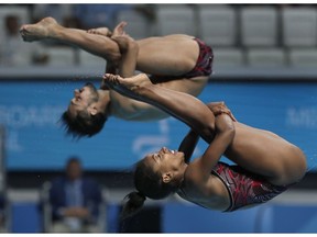 Canada's Jennifer Abel, front, and her teammate Francois Imbeau-Dulac perform during the mixed 3 meter springboard diving final at the 17th FINA World Championships 2017 in Budapest, Hungary, Saturday, July 22, 2017. (AP Photo/Michael Sohn) ORG XMIT: SOB127
Michael Sohn, AP