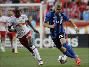 Montreal Impact defender Kyle Fisher, right, drives the ball against New York Red Bulls forward Bradley Wright-Phillips during the first half of an MLS soccer game, Saturday, July 29, 2017, in Harrison, N.J.