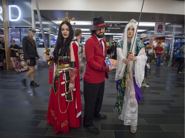 From left, Audrey Leamay as a Diablo 3 wizard, Kevin Beaulieu as Twisted Fate from League of Legends and Sandrine Levesque wearing an original creation, all of Quebec City, pose outside the Montreal Comiccon on Saturday, July 8, 2017.