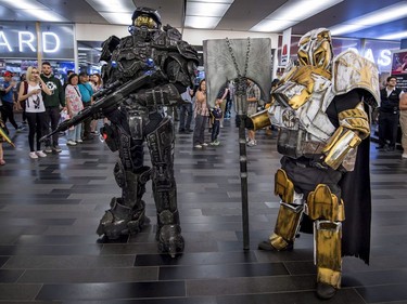 Frank Roy, left, dressed as Heavy Master Chief of Halo Fame, and Frederick Villeneuve, right, as Lord Saladin of Destiny pose outside the Montreal Comiccon on Saturday, July 8, 2017.