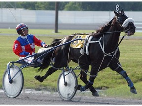 Hervé Filion, seen here in  2002 riding Napa's Jokester, warms up prior to the start of the first race at Harrington Raceway in Harrington, Del.