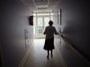 A woman, suffering from Alzheimer's disease, walks in a corridor on March 18, 2011 in a retirement house in Angervilliers, eastern France. No, says Joe Schwarcz, contrary to what it says somewhere on the internet, shampoos do not cause Alzheimer's.