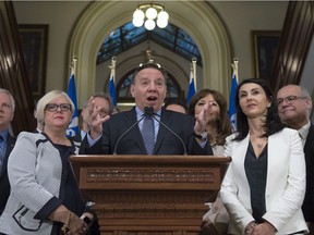 Coalition Avenir Québec Leader François Legault, centre, speaks at a news conference marking the end of the spring session, Friday, June 16, 2017 at the legislature in Quebec City. Legault is accompanied by members of his caucus.