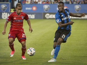 Montreal Impact's Ballou Tabla makes a pass as FC Dallas' Michael Barrios, defends.