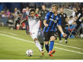 Montreal Impact's Kyle Fisher, right, challenges D.C. United's Jose Guillermo Ortiz during second half MLS soccer action in Montreal, Saturday, July 1, 2017. THE CANADIAN PRESS/Graham Hughes