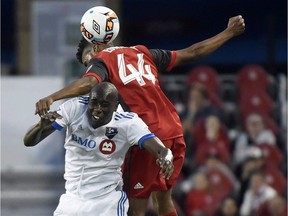 "We have to be smart and focused and then we'll have a good chance to win at home," says Montreal Impact defender Hassoun Camara, botttom, battling Toronto FC forward Raheem Edwards during second half Canadian Championship soccer action in Toronto on Tuesday, June 27, 2017.