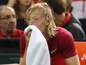 Denis Shapovalov of Richmond Hill, Ont., reacts after accidentally hitting head referee Arnaud Gabas during third set action against Kyle Edmund of Great Briatain.