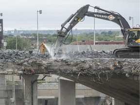 Construction crews pictured demolishing the St-Jacques overpass in July 2016. According to Transport Quebec, the street is due to be reopened at the end of 2018.