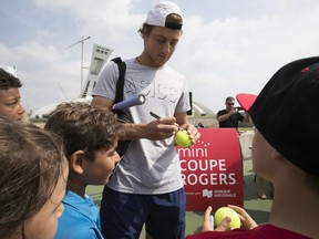 Tennis player Brayden Schnur signs autographs for young players at the press conference to inaugurate this year's Mini Rodgers Cup at Olympic Stadium on Thursday August 3, 2017.