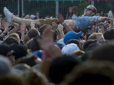 A crowd-surfer takes a ride during Run the Jewels' performance on Day 3 of the Osheaga Music and Arts Festival at Parc Jean-Drapeau in Montreal on Sunday, Aug. 6, 2017.