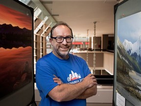 Wikipedia founder Jimmy Wales stands among the prints from across Canada that were selected for the Wiki Loves Earth photo contest on display for the Wikimania conference in Montreal.