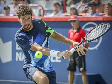 Robin Hasse hits a backhand return during his straight-set defeat at the hands of Roger Federer in the semi-final match of the Rogers Cup tennis tournament in Montreal on Saturday August 12, 2017.