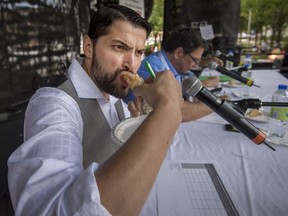 Italian chef and tenor Davide Bazzali samples an entry at Montreal Italian Week's cannoli contest on Aug. 13, 2017.