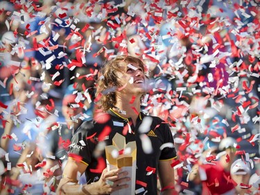 Alexander Zverev looks up at the crowd through confetti after winning the championship match over Roger Federer at the Rogers Cup tennis tournament at Uniprix Stadium in Montreal Sunday, Aug. 13, 2017.