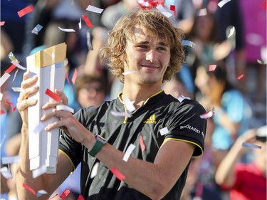 Alexander Zverev is showered with confetti after being presented with the championship trophy after his victory over Roger Federer at the Rogers Cup tennis tournament at Uniprix Stadium in Montreal on Sunday, Aug. 13, 2017.