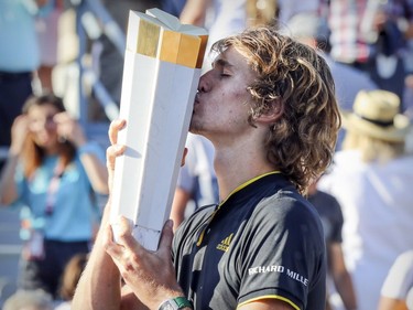 Alexander Zverev kisses the champion's trophy after winning the final match over Roger Federer at the Rogers Cup tennis tournament at Uniprix Stadium in Montreal on Sunday, August 13, 2017.