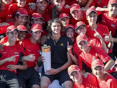 Alexander Zverev poses for a picture with ballboys and ballgirls after winning the championship match over Roger Federer at the Rogers Cup tennis tournament at Uniprix Stadium in Montreal on Sunday, August 13, 2017.