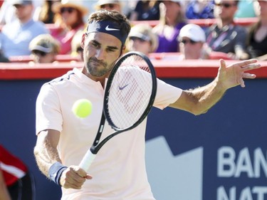 Roger Federer hits a backhand return during  the championship match against Alexander Zverev at the Rogers Cup tennis tournament at Uniprix Stadium in Montreal on Sunday, August 13, 2017.