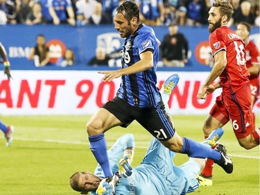 Chicago Fire goalkeeper Matt Lampson grabs Montreal Impact's Matteo Mancosu's foot to stop his breakaway during first half of MLS action in Montreal on Wednesday August 16, 2017. The Impact scored on the subsequent penalty kick.