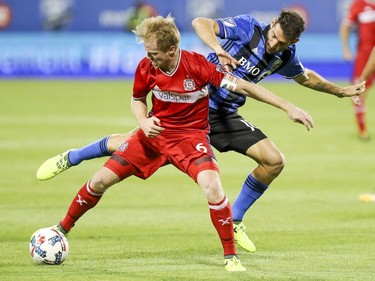 Montreal Impact's Ignacio Piatti, rear, tries to pick the ball away from Chicago Fire's Dax McCarty during first half of MLS action in Montreal on Wednesday August 16, 2017.