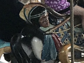 A carousel horse at La Ronde features a depiction of an Indigenous man's head in a bag.
