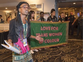 Kama La Mackerel, left, speaks out concerning issues faced by trans women of colour to attendees before they enter a conference held by Montreal Pride on Aug. 18, 2017.